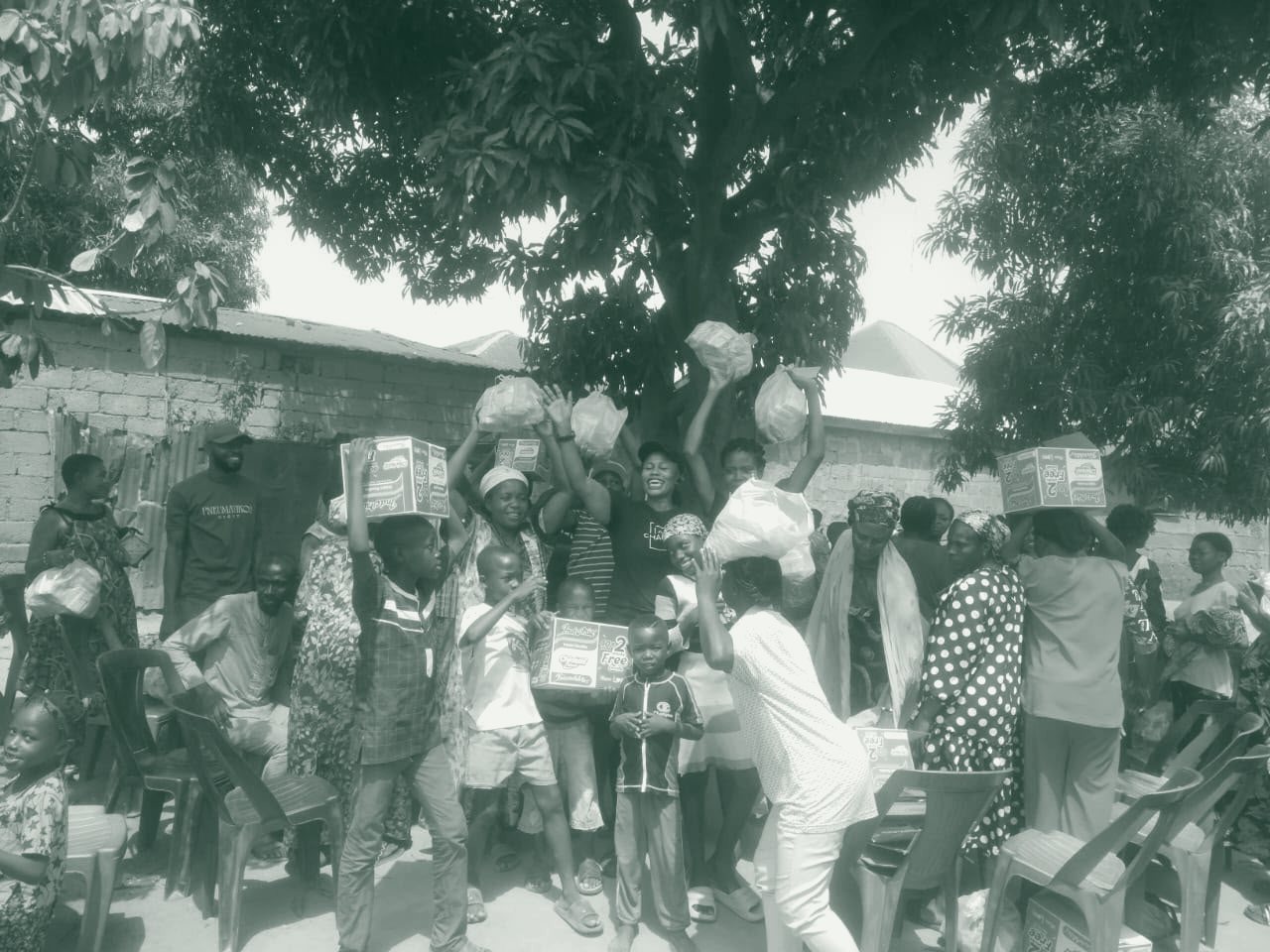 Families gather to receive food packages during a Fisho Initiative feeding outreach.